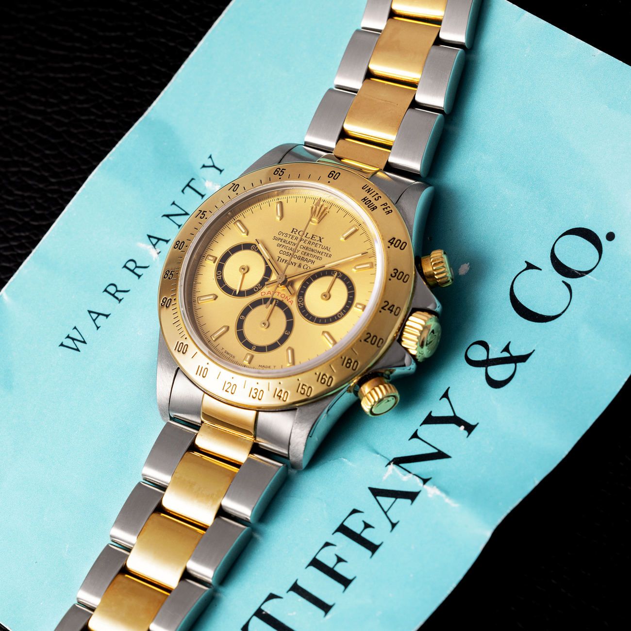 Lot 15 — Rolex Perpetual Daytona chronograph in steel and yellow-gold reference 16 523, with champagne dial. Retailed by Tiffany & Co. with warranty – View Lot