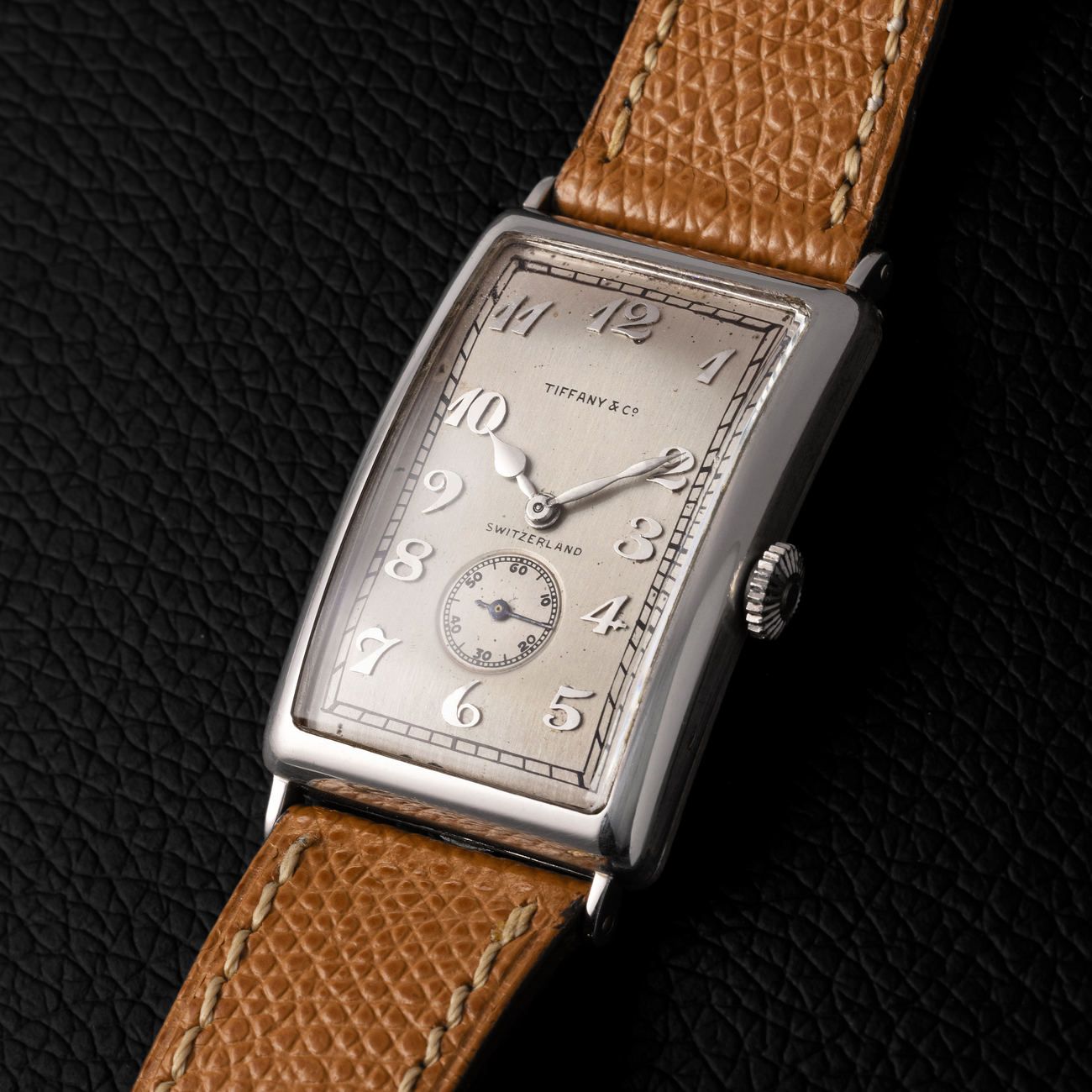 Lot 211 — Patek Philippe Oversize Rectangular Gondolo wristwatch in platinum with hinged back and applied Breguet numbers dial. Retailed by Tiffany & Co with extract from the archives – View Lot