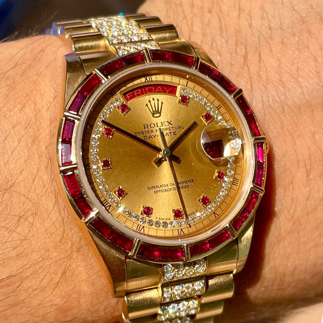 Rolex Day Date reference 18168 in 18k yellow gold with very rare Ruby baguette bezel and diamond and Ruby set dial, full diamond pave bracelet.