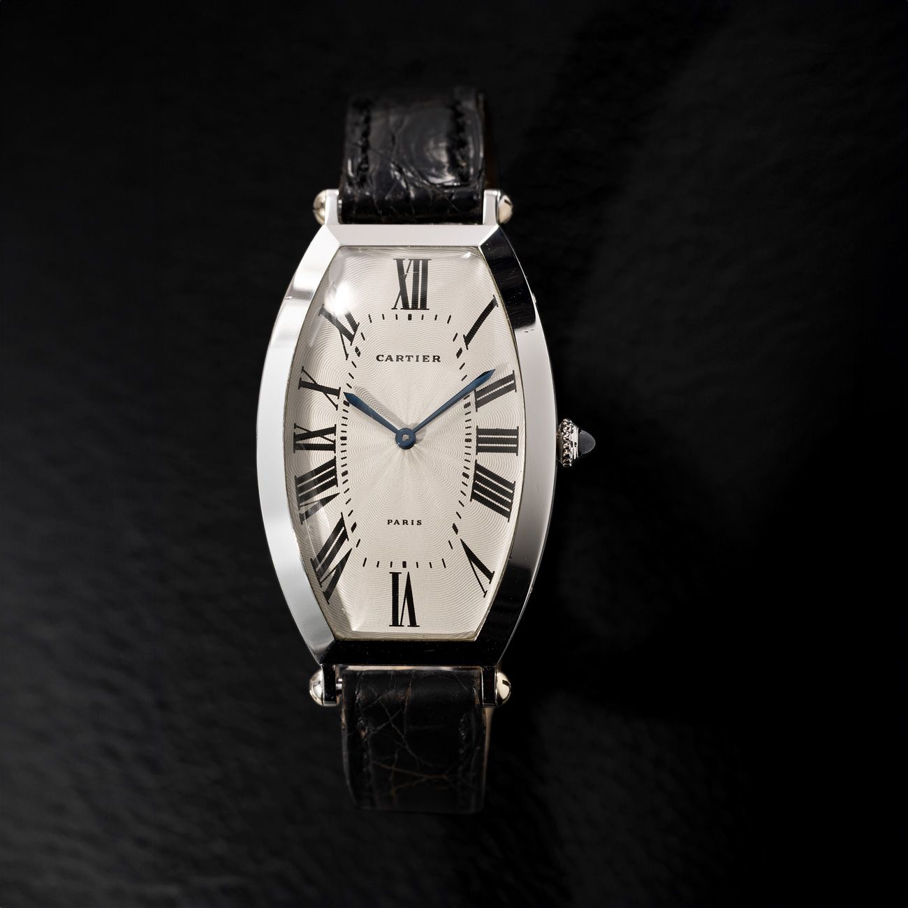 Cartier Tonneau, Platinum (1994)A well-preserved platinum Tonneau with an engine-turned dial and "Paris" signature, complete with its original warranty.