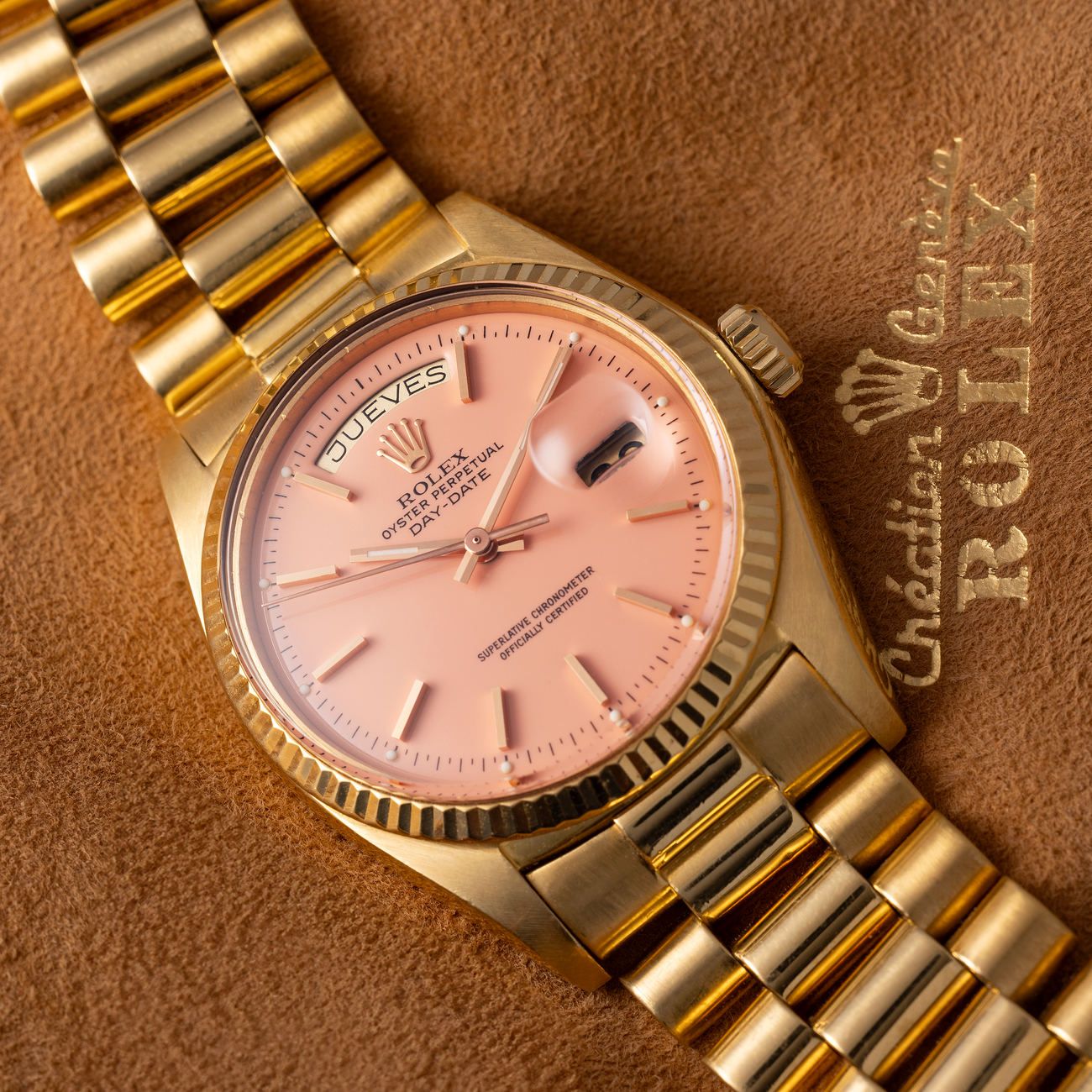 Lot 245 – Extremely rare Rolex Day-Date in yellow-gold reference 1803 with pink lacquered “Stella” dial. With box and papers. 