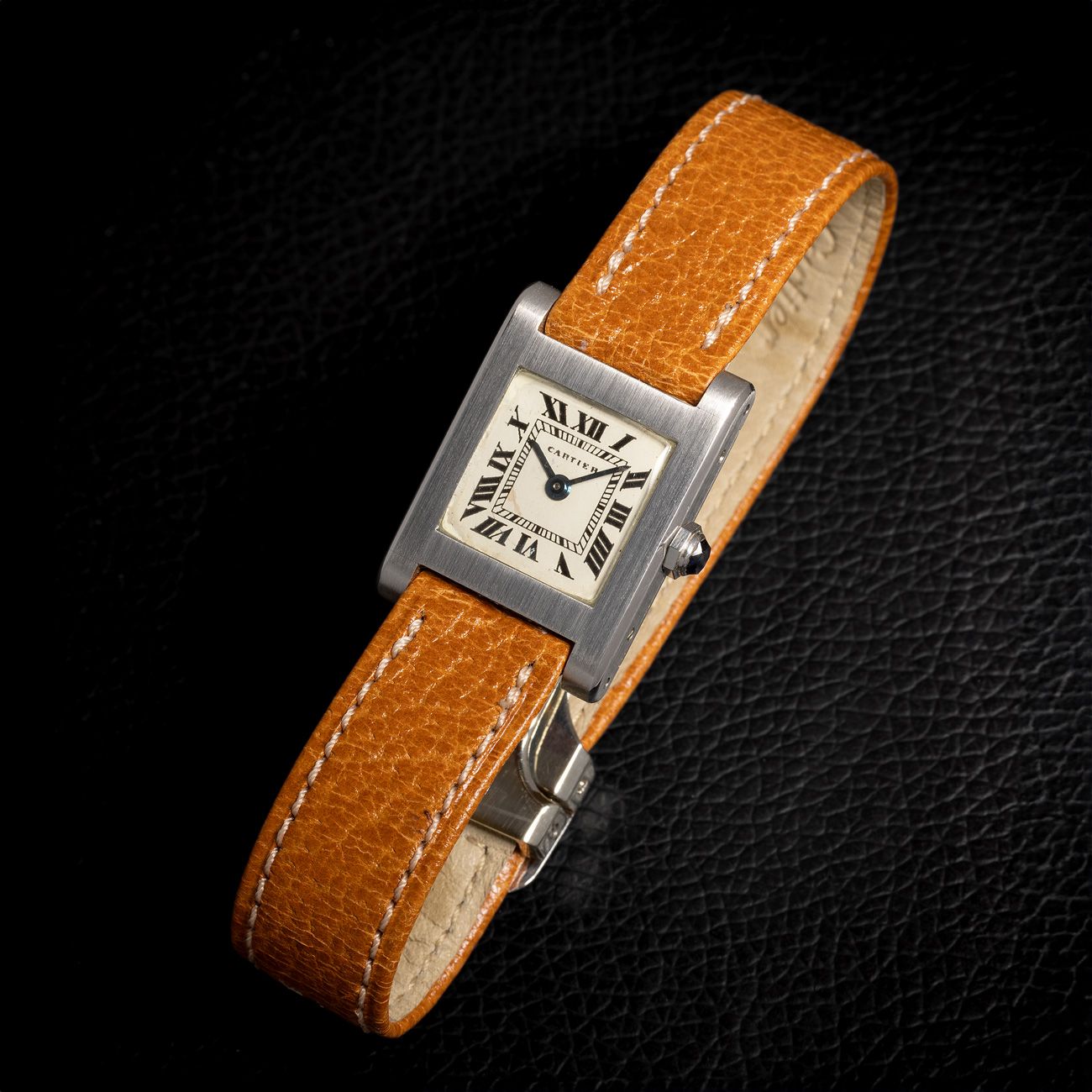 Cartier Tank Mini, Platinum (1960s)A very rare Tank Mini in platinum with a striking black Roman numeral dial, epitomizing Cartier's timeless elegance.