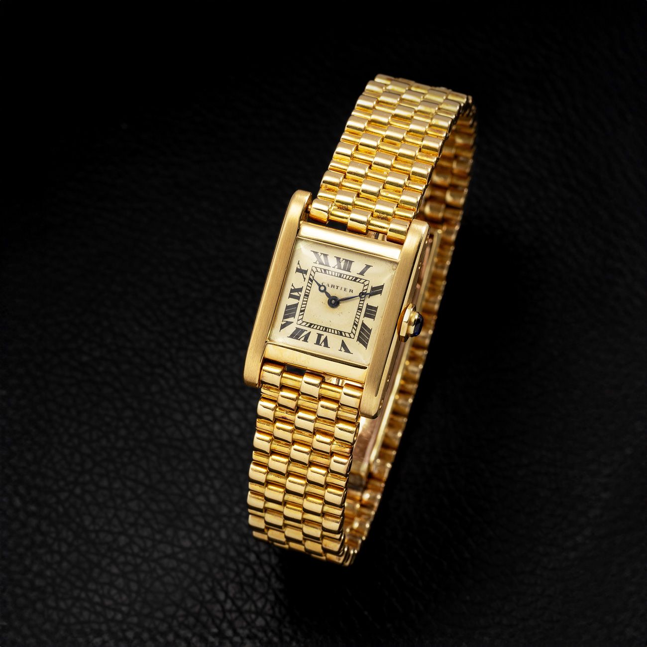Cartier Tank Normale, Yellow Gold (1950s)A beautiful yellow-gold Tank Normale with a beautifully aged cream dial and special bracelet, showcasing timeless simplicity.