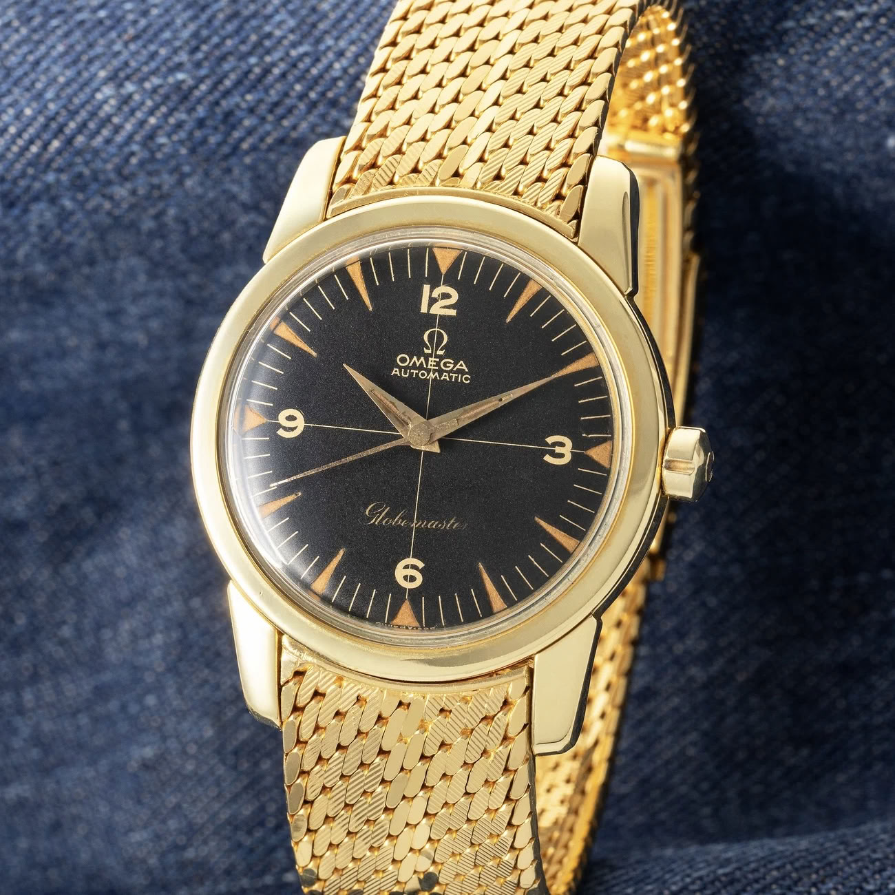 Lot 11 - Exceptionally preserved and rare Globemaster in yellow gold with black crosshair dial and original gold Omega bracelet.