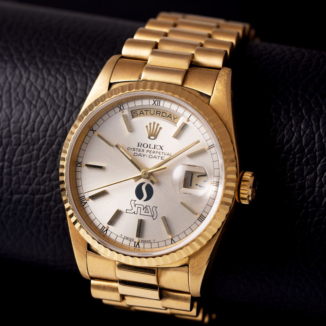 Lot 77 – Rolex Day-Date in yellow-gold reference 18 238, with SNAS logo dial.