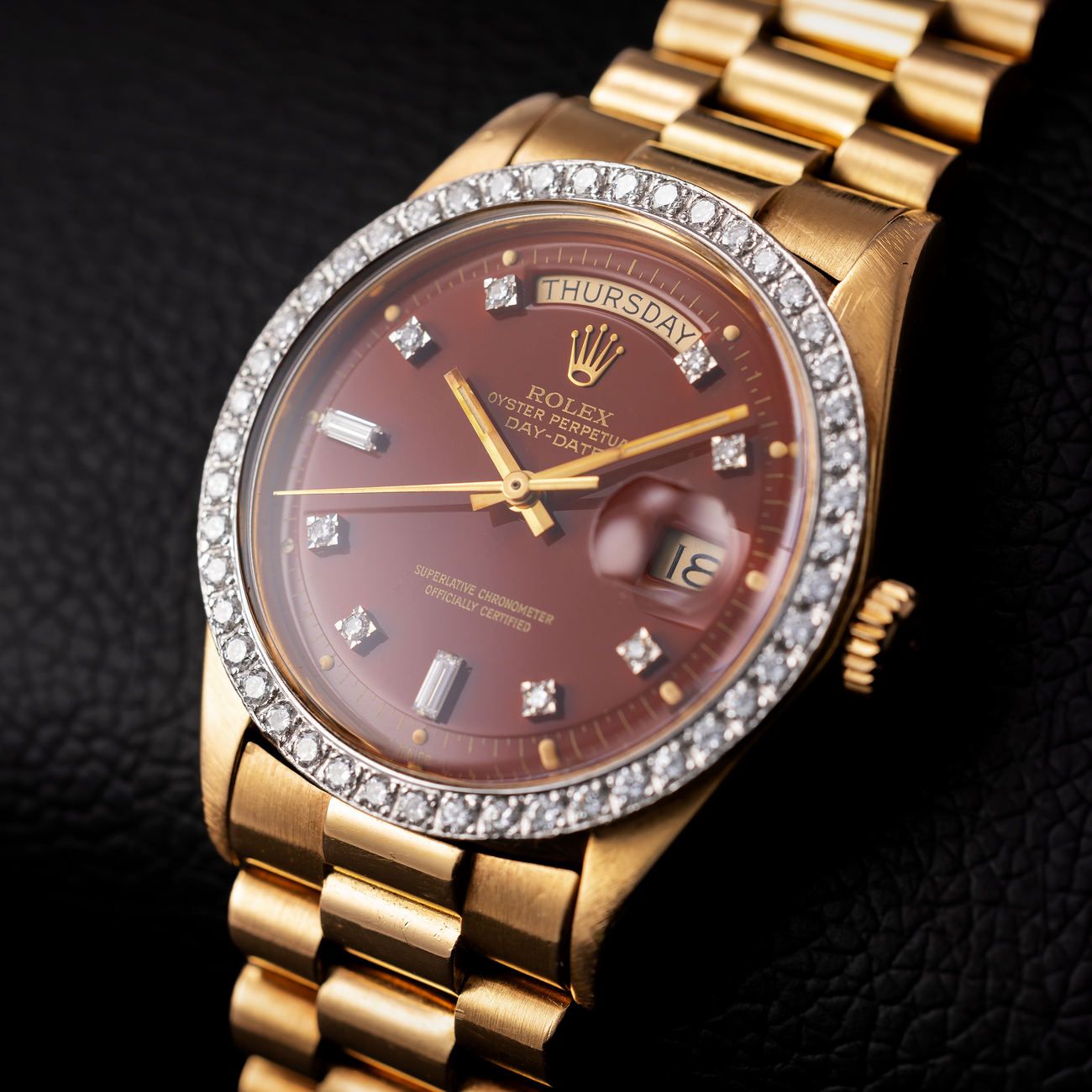 Lot 160 – Rolex Day-Date reference 1804, with burgundy diamond “Stella” dial and diamond-set bezel.