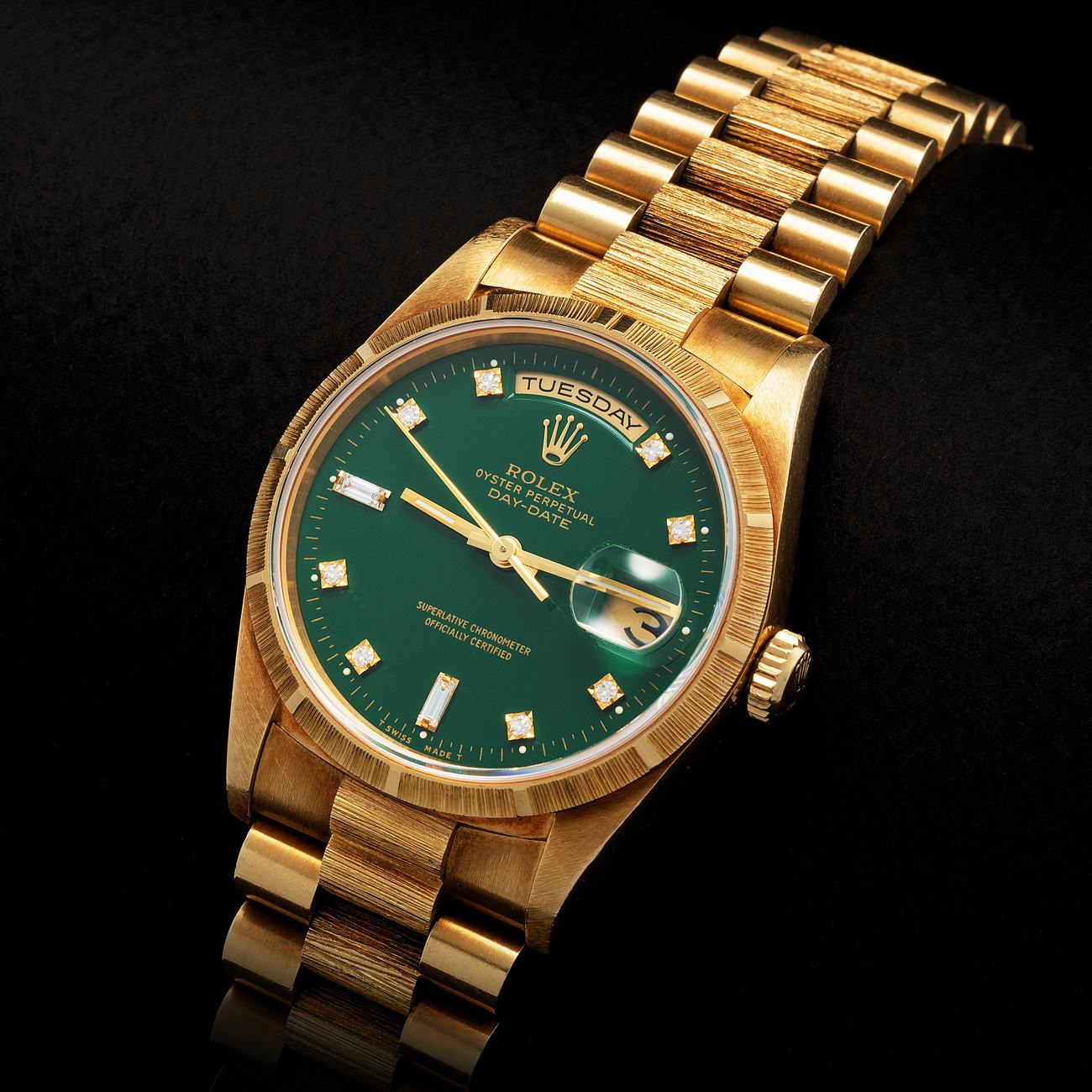 Lot 120 - Very Rare and Esteemed, Day-Date Bark Finish, Automatic Wristwatch in Yellow Gold, Lacquered Green and Diamond-Set Dial, Reference 18248 – Estimate: € 50,000 – 100,000 – View lot detail