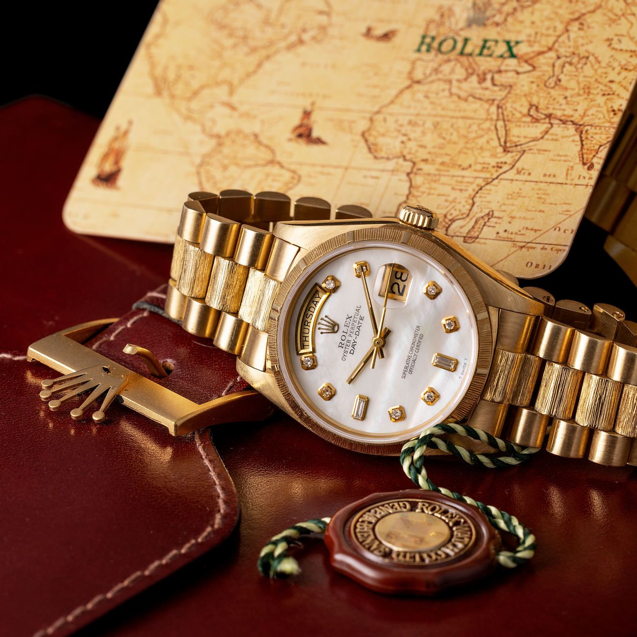 Lot 28 – Bark finish Day-Date in yellow-gold reference 18 038, with rare diamond-set mother-of-pearl dial.