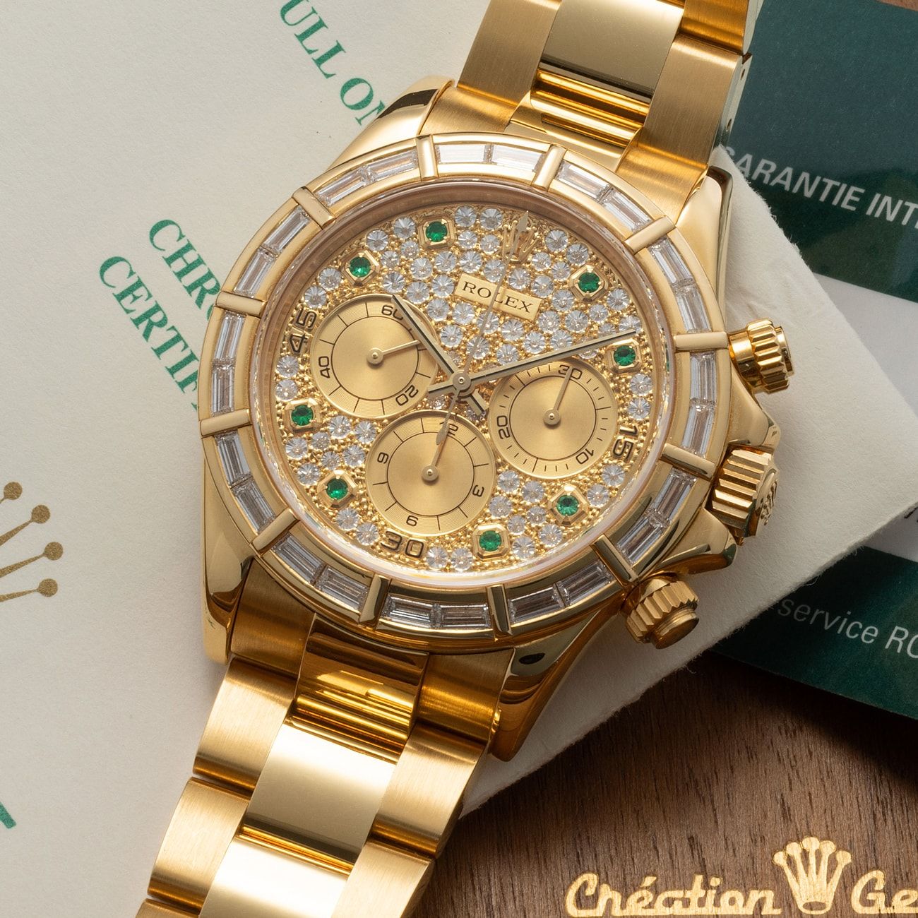 Lot 257 - Absolutely Exceptional, Rare and Very Attractive, Daytona, Chronograph Wristwatch in Yellow Gold, With Diamond-Emerald Set Dial and Baguette Diamond Bezel, Reference 16568, Published in Pucci Papaleo’s Book “Daytona Perpetual”, With Confirmation Letter, Box and Warranty – Estimate: € 200,000 – 400,000 – View lot detail