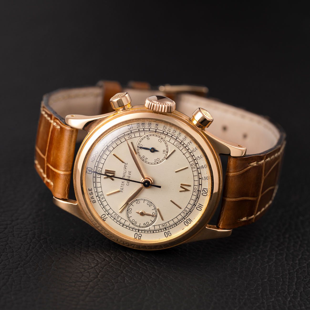 Lot 90 – Patek Philippe Tasti Tondi reference 1463 chronograph in pink gold, with tachymeter scale dial and extract from the archives.