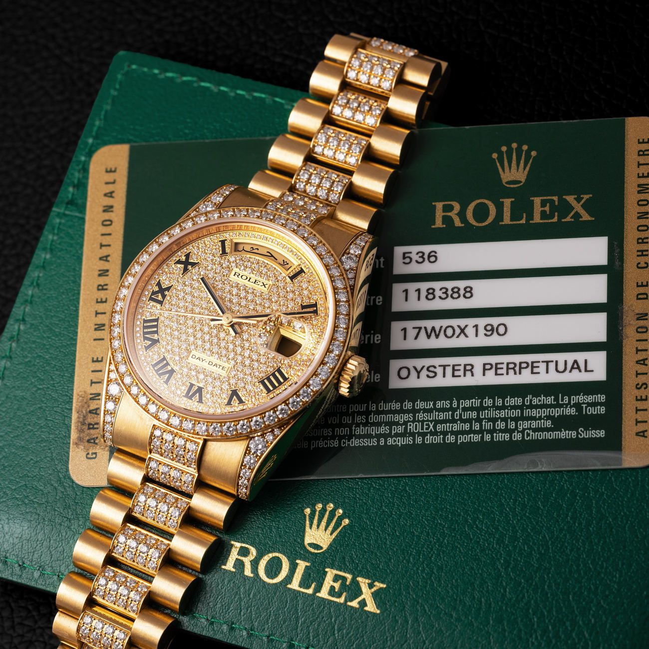 Lot 280 – Incredible Rolex Day-Date in yellow-gold reference 118 388, with pavè diamond dial, Arabic calendar, diamond-set bezel, lugs and bracelet. Complete with box, papers, tag and additional links.