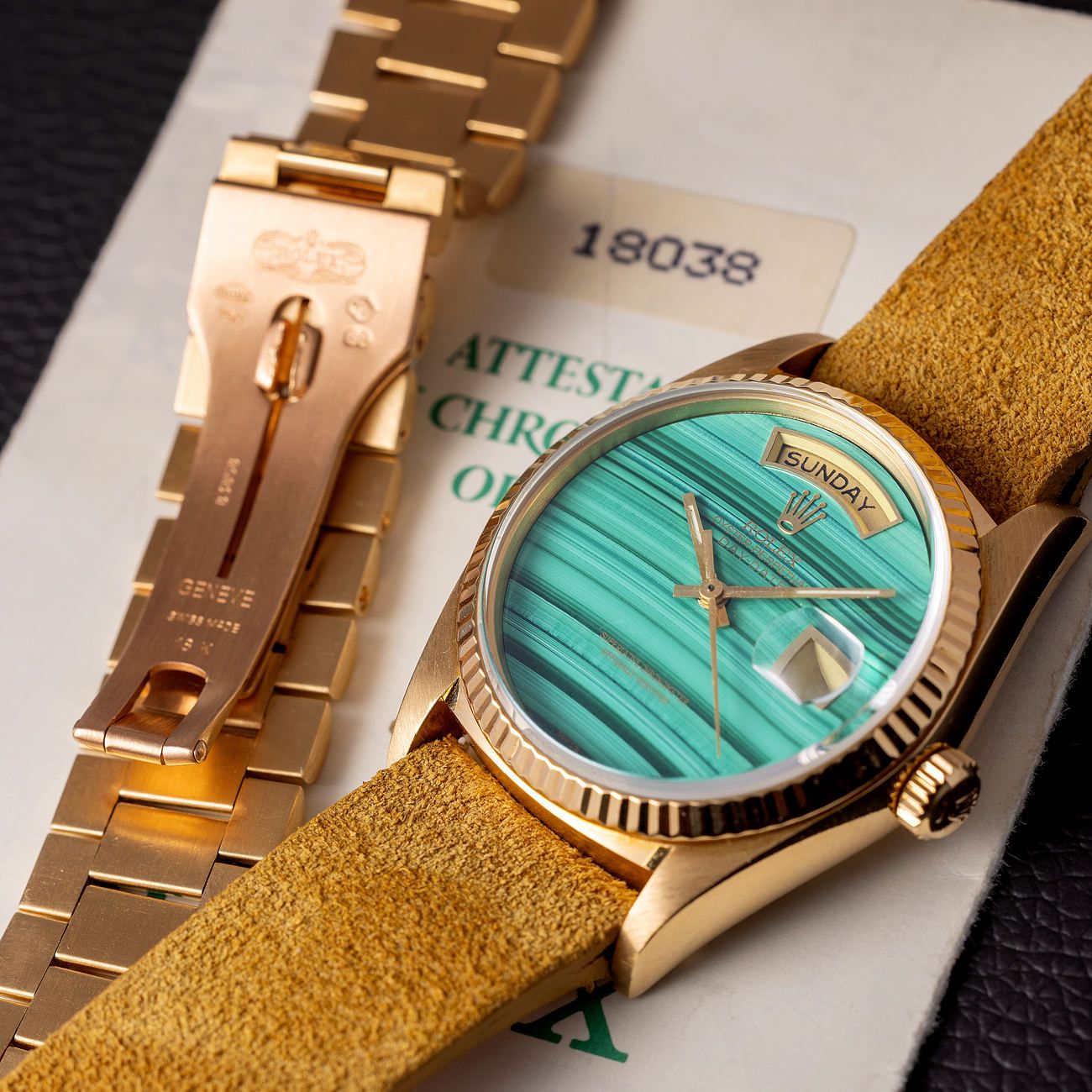 Lot 31 – Rolex Day-Date in yellow-gold reference 18 038 with malachite dial. Accompanied by original warranty.