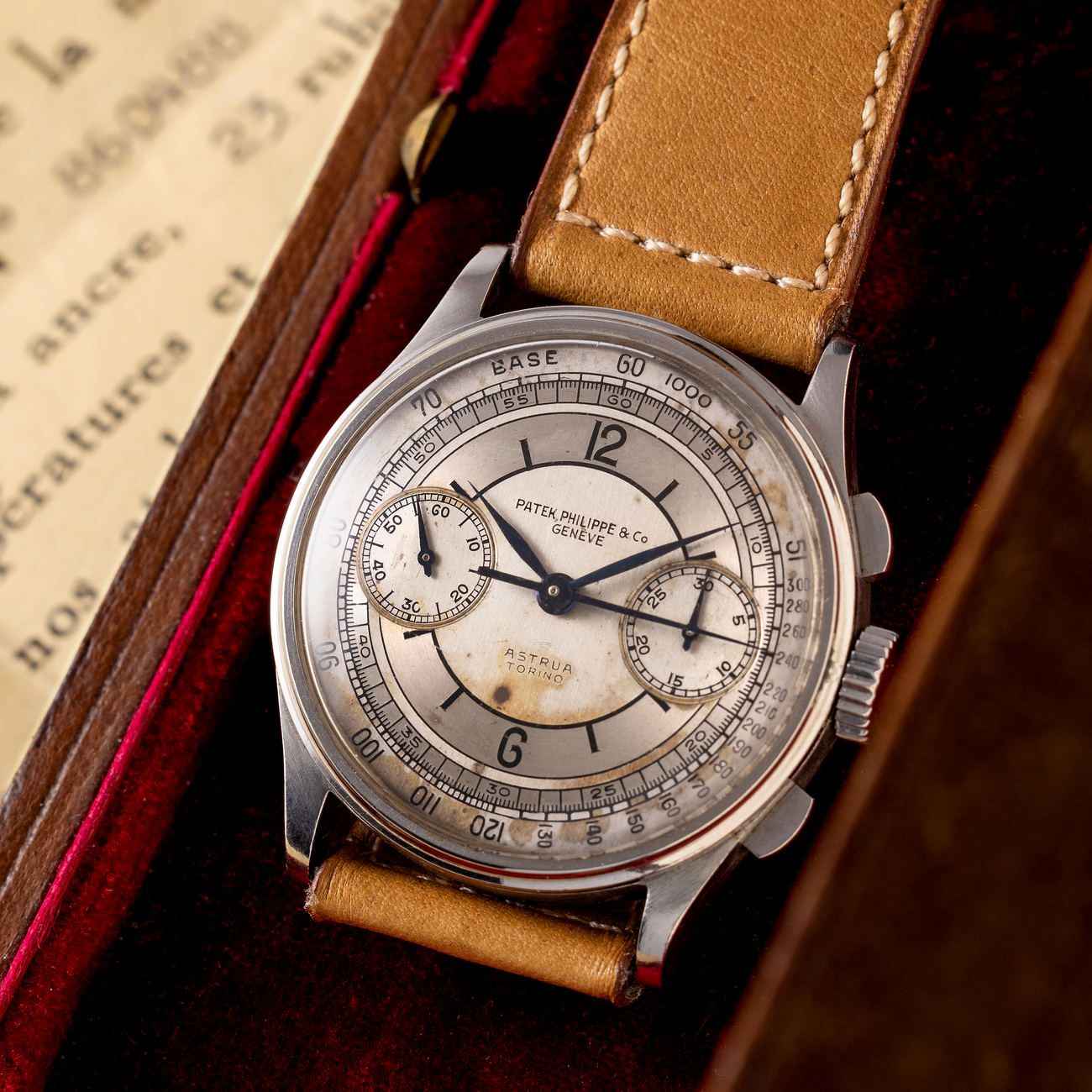 Lot 172 – From the original owner’s family, a Patek Philippe Reference 130 stainless steel chronograph featuring a rare three-tone silvered sector dial with enamelled Arabic numerals and signature “ASTRUA TORINO” at six o’clock. 