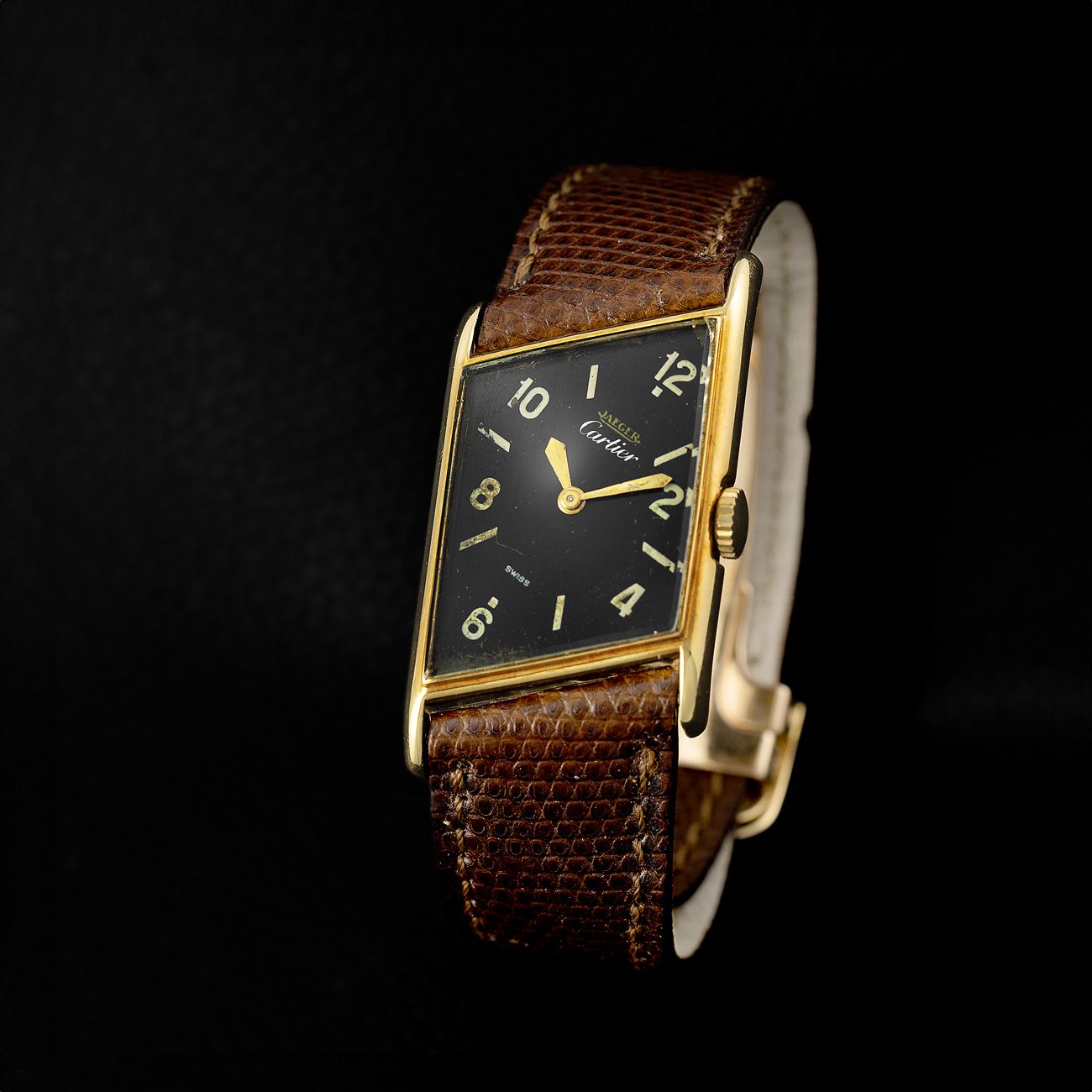 Cartier Asymmetric, Yellow Gold (1950s)A possibly unique Asymmetric model with a Jaeger Cartier black dial.