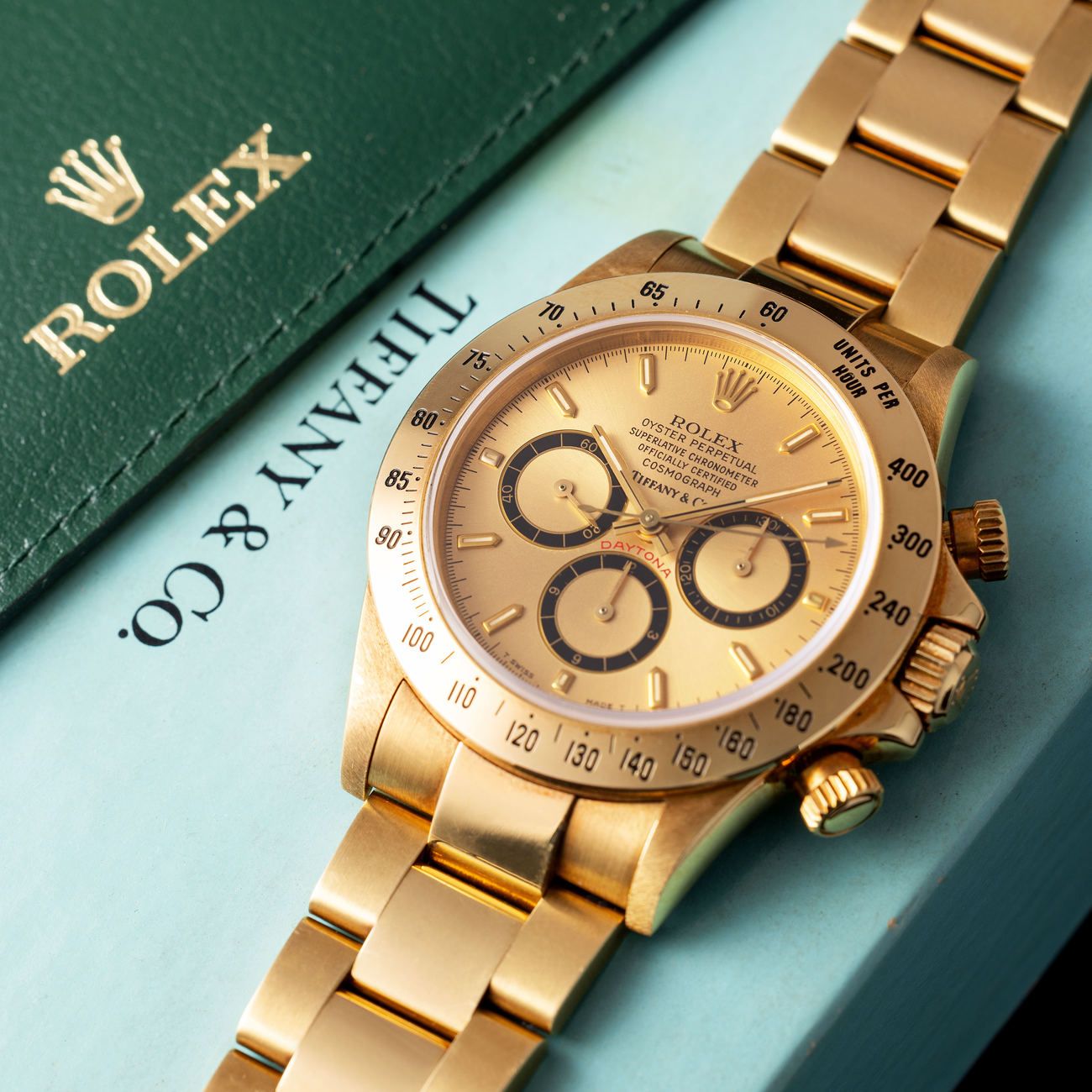 Lot 154 — Rolex Perpetual Daytona chronograph in yellow-gold reference 16 528, with champagne dial. Retailed by Tiffany & Co with box, warranty and Pucci Papaleo letter – View Lot