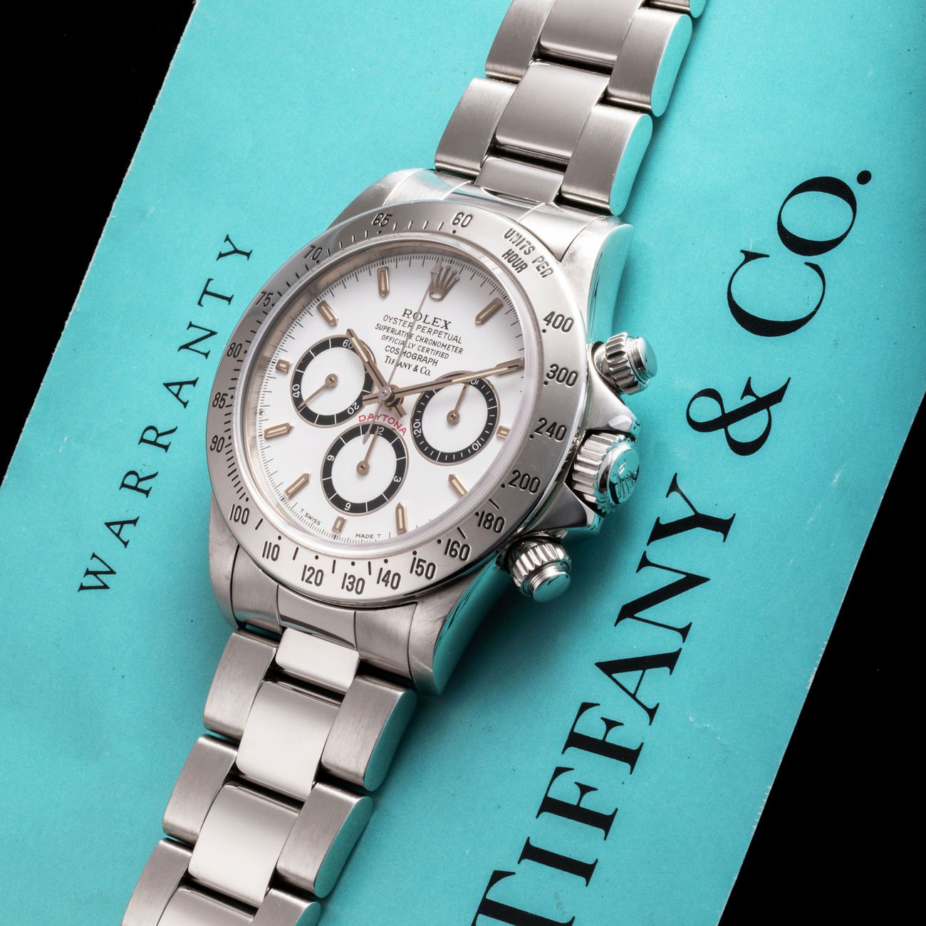 Lot 171 — Rolex Perpetual Daytona chronograph in steel reference 16 520, with white dial. Retailed by Tiffany & Co, with box, Tiffany’s warranty and service – View Lot