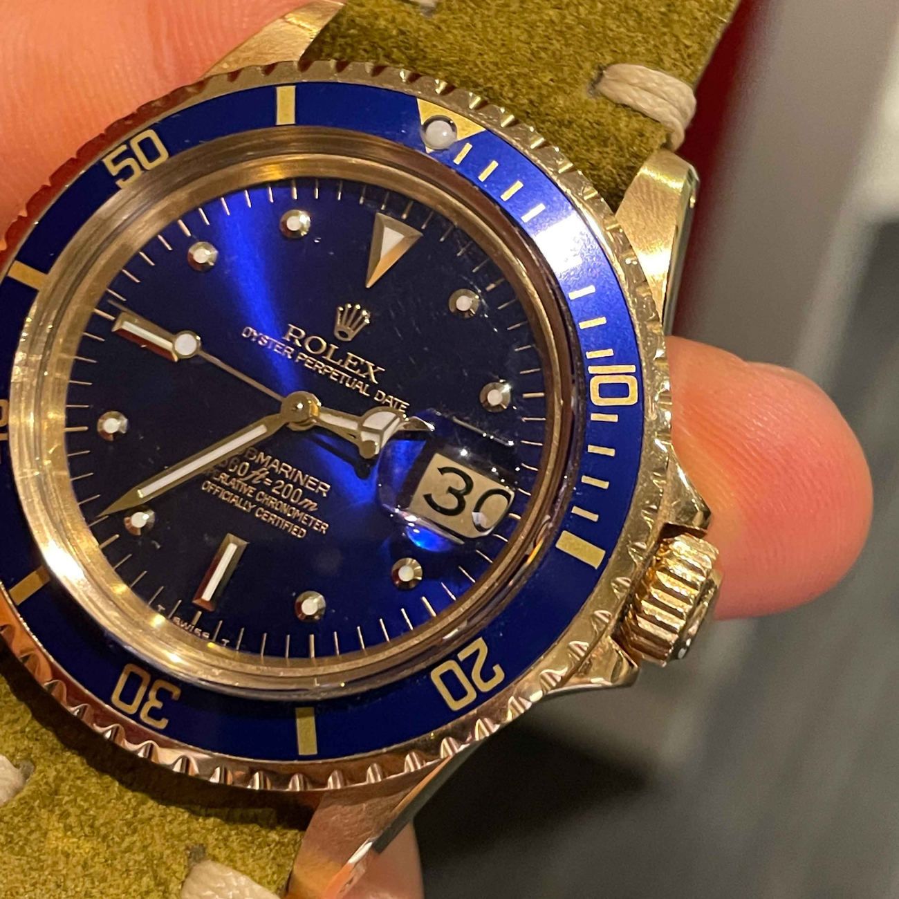 Rolex Submariner reference 1680 in 18k yellow gold with blue bezel and dial.