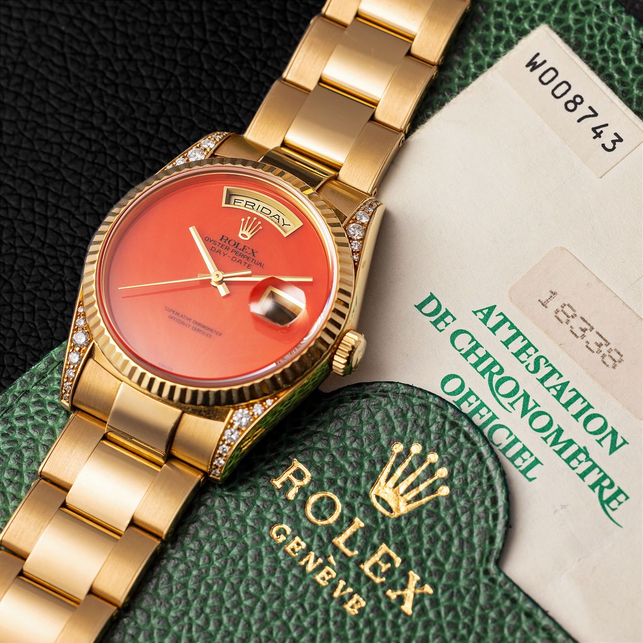 Lot 182 – Probably unique Rolex Day-Date in yellow-gold reference 18 338 with diamonds lugs and Coral dial. Complete with warranty